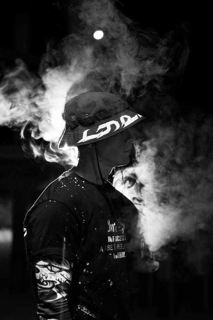 Black and white portrait of a man in smoke, creating a mysterious and moody feel.